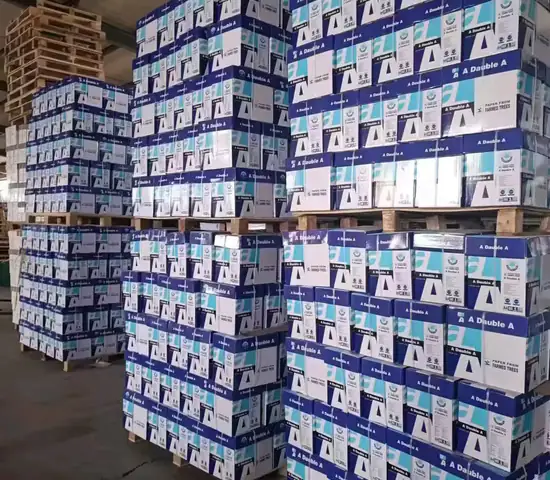 Pallets of boxed copier paper reams in a warehouse