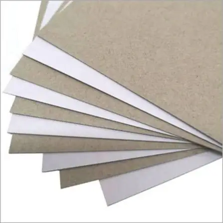 Duplex board sheets fanned out, showing the grey back and white top